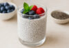 Puddling z nasionami chia, w tle nasiona w miseczce i jagody