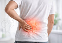 Mężczyzna trzymający się za nerki (widoczny ból nerek)